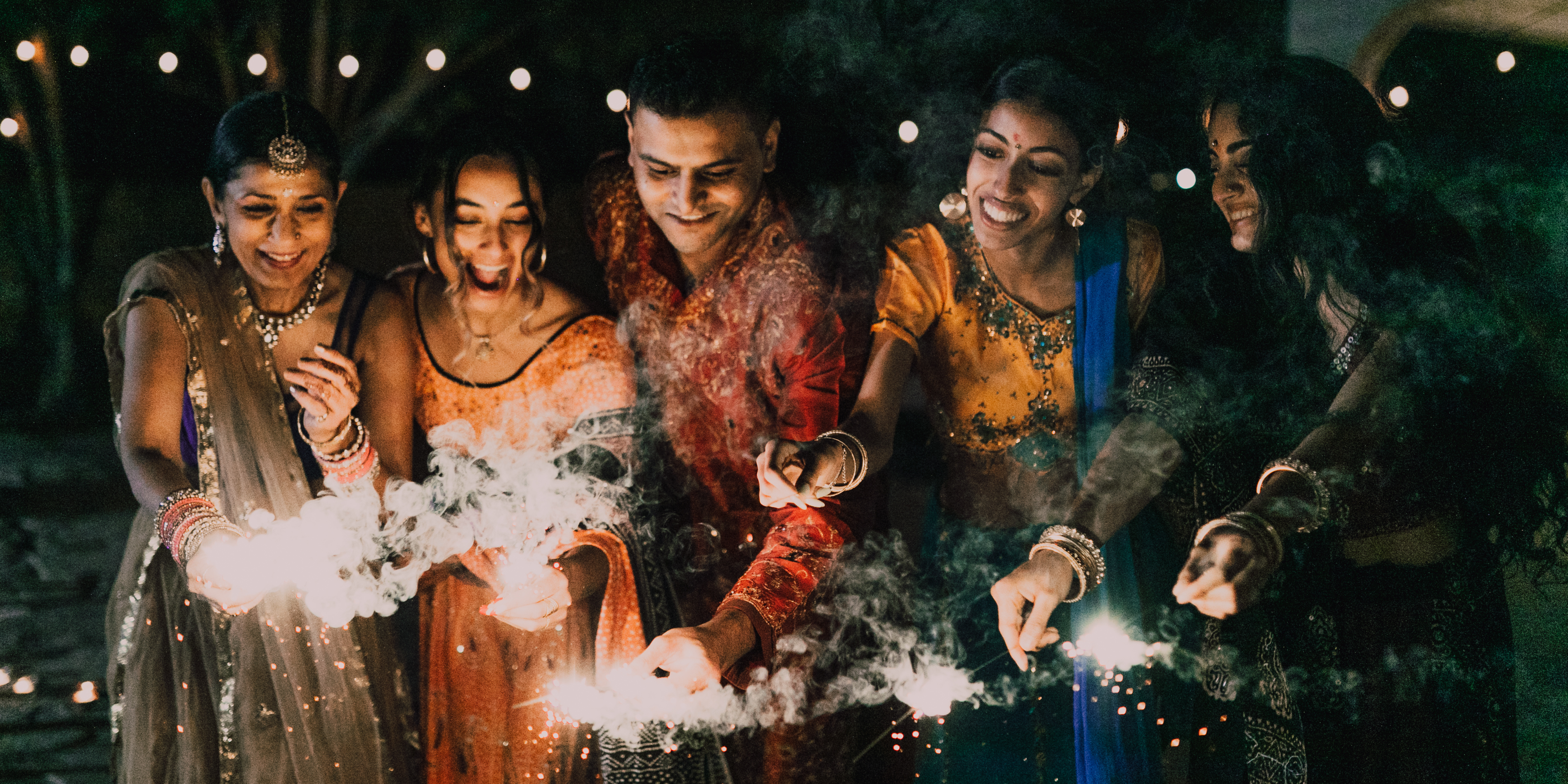 A group of 5 celebrating diwali with sparklers